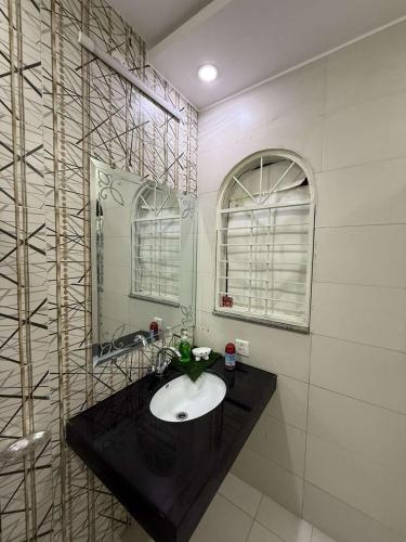 a bathroom with a sink and a mirror at The Cozy Nest in Lahore