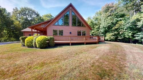 a house on a grassy field in front of a house at Beechwood Home in Mendon