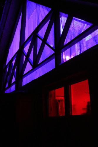 a room with a window with blue and purple lights at budabu in Sighnaghi