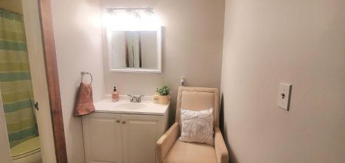 a bathroom with a sink and a toilet and a mirror at Gateway Condo A25 in Mendon