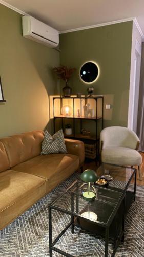 a living room with a couch and a table at The Green Nest in Surčin