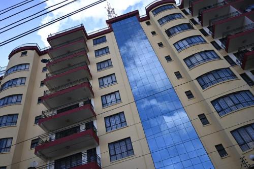 a building with a reflection of the sky in the windows at Milele Homes- Ruaka View Aprt in Nairobi