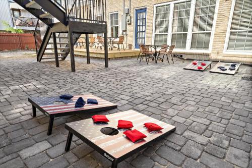 a patio with two tables with hats and a piano at Museums Cozy Med Center Apt BBQ Fire Pit Games in Houston