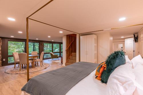 a bedroom with a large bed and a dining room at Blue Ridge Retreat at Linville Land Harbor in Newland