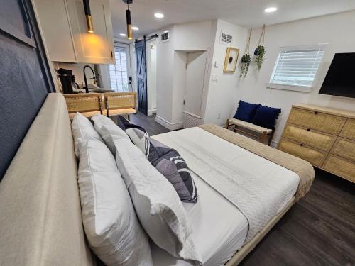 a bedroom with a large bed with pillows at The Hideaway DT Orlando Tiny Home w Free Parking in Orlando
