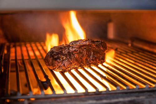 a piece of meat on a grill in an oven at Berlin Marriott Hotel in Berlin