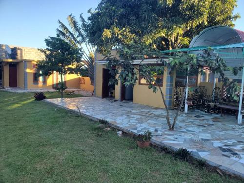a house with a garden and a stone patio at Gipir & Labango Ventures in Entebbe