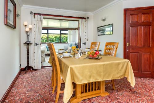 uma sala de jantar com uma mesa com uma toalha de mesa amarela em B&B Meadow View em Penrith
