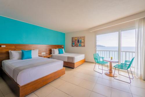 Ένα ή περισσότερα κρεβάτια σε δωμάτιο στο Hotel Amares Acapulco