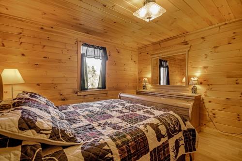 a bedroom with a bed in a log cabin at Mountain-View Deck! Cabin By Mt Abraham Trails in Kingfield