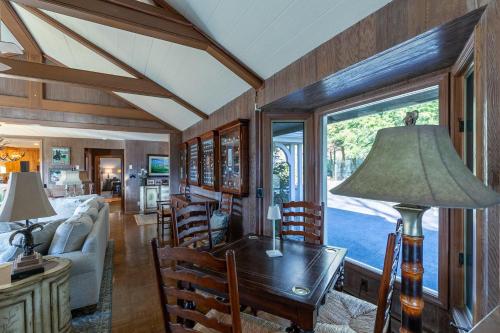 a living room with a table and a couch at Hinesight at Hound Ears in Valle Crucis
