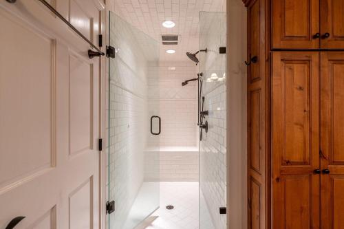 a shower with a glass door in a bathroom at Hinesight at Hound Ears in Valle Crucis