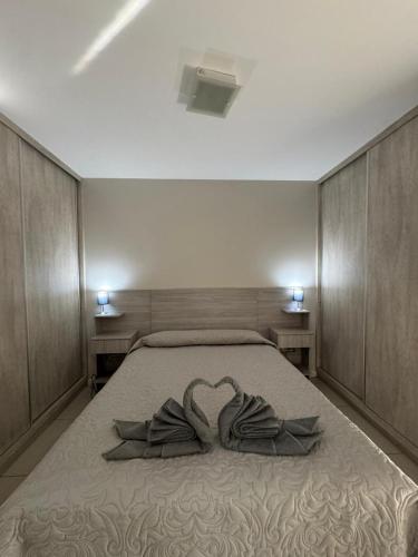 a bedroom with a bed with a pair of gloves at Departamento Turistico Consorcio MA in San Juan