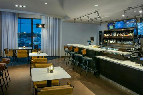 a restaurant with a bar and tables and chairs at Courtyard Richland Columbia Point in Richland