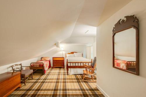 a living room with a bed and a mirror at Lakes View at Hound Ears in Valle Crucis