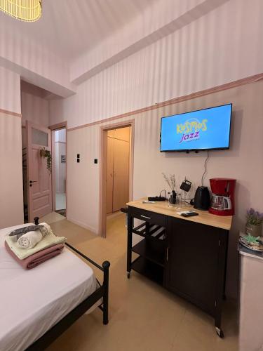 a bedroom with a desk and a sign on the wall at Classic rooms in the center in Loutraki