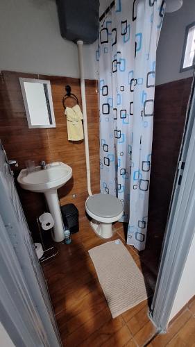 a bathroom with a sink and a toilet at casa kitnet in Maracaju