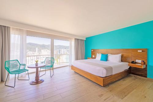 Ένα ή περισσότερα κρεβάτια σε δωμάτιο στο Hotel Amares Acapulco
