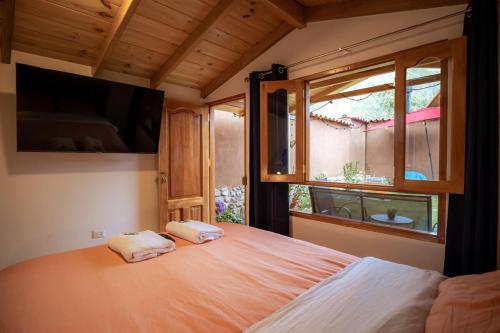 Ένα ή περισσότερα κρεβάτια σε δωμάτιο στο Tiny house con tina medicinal