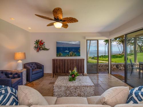 a living room with a couch and a ceiling fan at Wailea Elua Village 1301 in Wailea