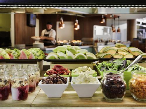 a buffet line with many different types of food at Novotel Queenstown Lakeside in Queenstown