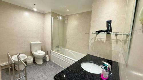a bathroom with a sink and a toilet and a shower at Sea Haven in Funchal