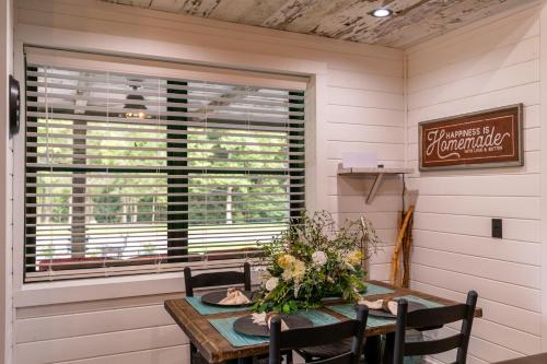 a dining room with a table and a window at Up the Creek in Linville