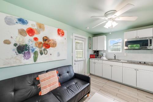 a living room with a couch and a kitchen at Barefoot Bungalow SPV26 in Port Aransas