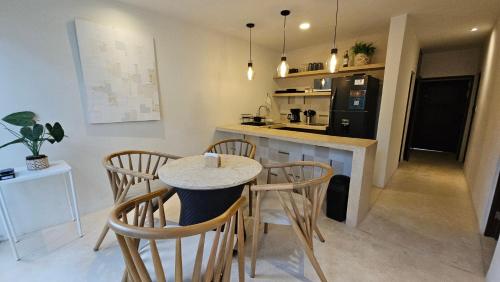 a kitchen with a table and chairs in a room at Casa Arrayan Telchac in Telchac Puerto
