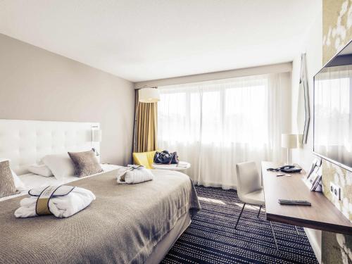 Postel nebo postele na pokoji v ubytování Mercure Bourg En Bresse