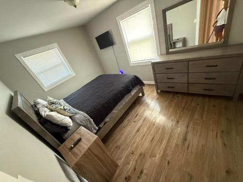 a bedroom with a bed and a dresser and a mirror at Bay view suites in Sarasota