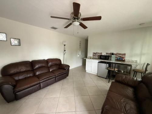 a living room with a couch and a ceiling fan at Bay view suites in Sarasota