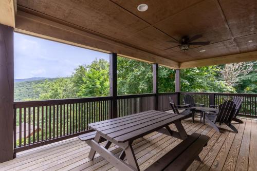 a porch with a picnic table and chairs on a deck at Starlight Ridge in Seven Devils