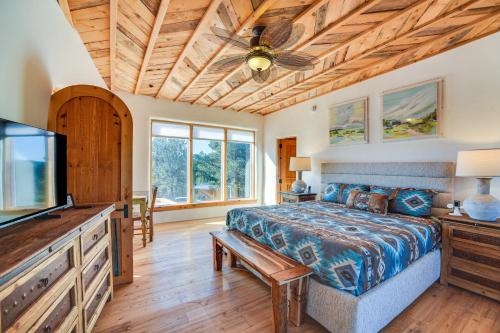 a bedroom with a bed and a flat screen tv at Panoramic Vistas Glorieta Adobe Near Pecos River in Glorieta