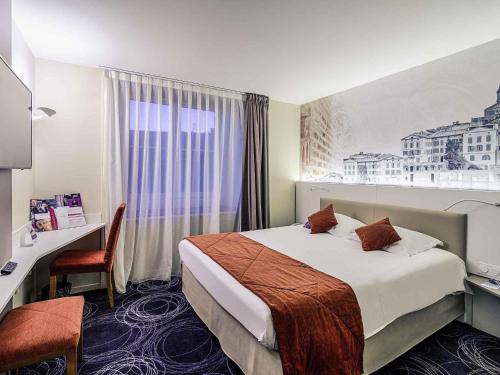 Ένα ή περισσότερα κρεβάτια σε δωμάτιο στο Mercure Albi Rives du Tarn