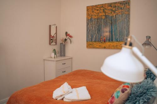 a bedroom with a bed with two towels on it at ZevenVrijeDagen in Ghent