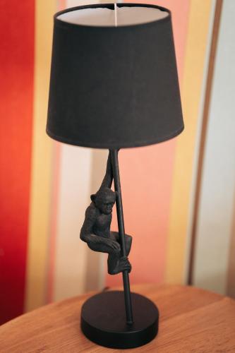 a black figurine of a cat sitting on a lamp at ZevenVrijeDagen in Ghent