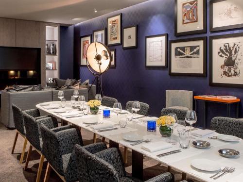 a dining room with a table and chairs at Sofitel Paris Arc De Triomphe in Paris