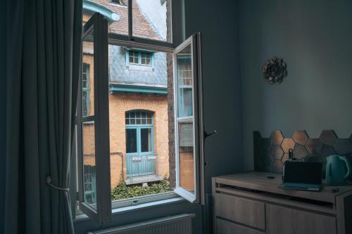 an open window with a view of a building at ZevenVrijeDagen in Ghent