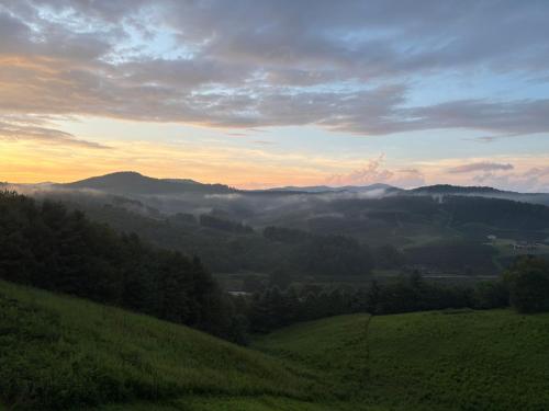 a view of a valley with fog in the hills at Chasing Clouds Cabin in Todd