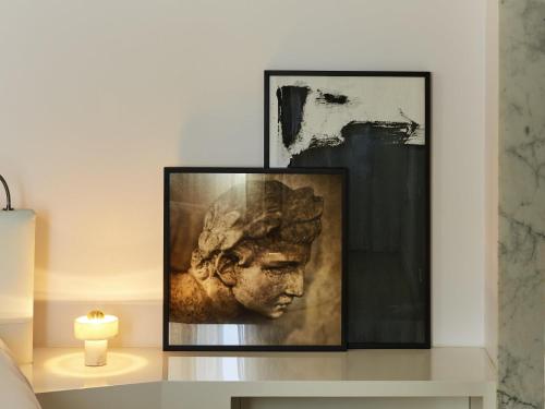 a picture of a head on a table with a candle at Sofitel Roma Villa Borghese in Rome