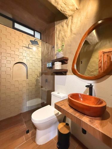 a bathroom with a wooden sink and a toilet at Hotel Quincha y Adobe in Huanchaco