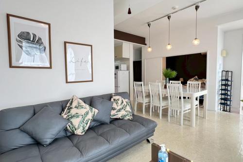 a living room with a couch and a dining room at パイナガマリゾート AZAMi-8 in Miyako-jima