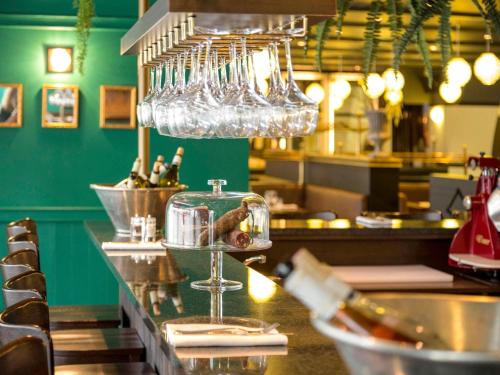 a restaurant with a bar with wine glasses at Ibis Paris Tour Eiffel Cambronne 15ème in Paris