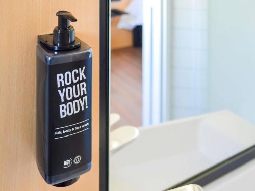 a soap dispenser is attached to a door at Ibis Paris Tour Eiffel Cambronne 15ème in Paris