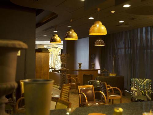 a dining room with chairs and pendant lights at Ibis Paris Tour Eiffel Cambronne 15ème in Paris