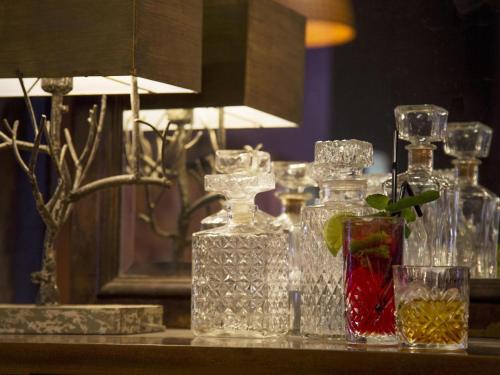 a group of glass bottles sitting on a table at Ibis Paris Tour Eiffel Cambronne 15ème in Paris