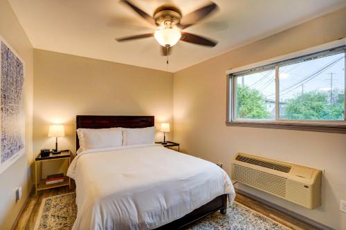 a bedroom with a bed with a ceiling fan and a window at Parking Pets Private Entrance Near Med Center in West Allis