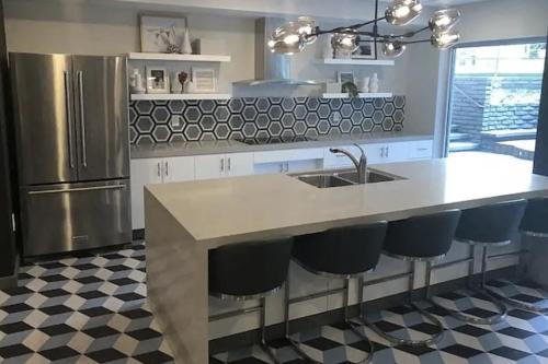 a kitchen with a counter with a sink and a refrigerator at Hollywood Studio with Pool, Parking and Gym in Los Angeles