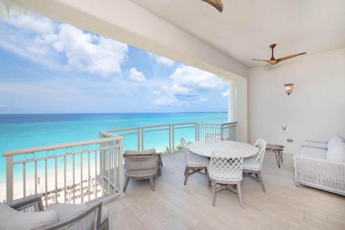 a dining room with a view of the ocean at Beachcomber 39 in George Town
